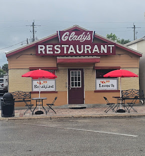 Gladys' Restaurant storefront with red umbrellas